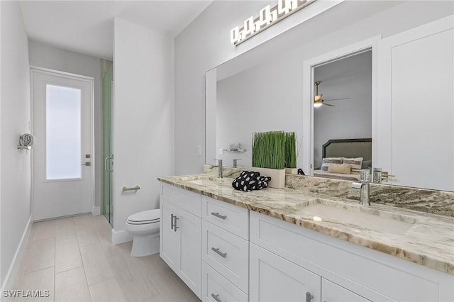 bathroom with tile patterned floors, an enclosed shower, vanity, ceiling fan, and toilet