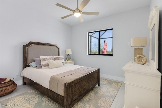 bedroom with ceiling fan and light hardwood / wood-style flooring