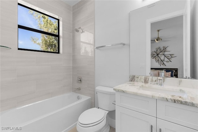 full bathroom with vanity, toilet, and tiled shower / bath combo