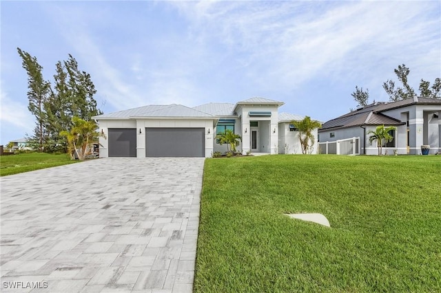 view of front of property with a garage and a front yard