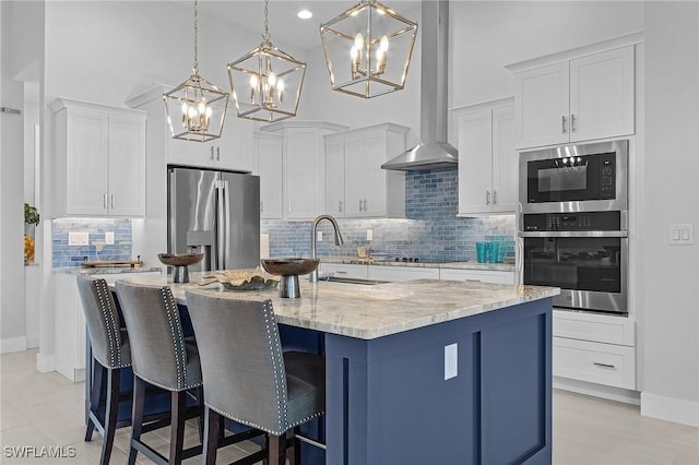 kitchen featuring white cabinets, decorative light fixtures, and appliances with stainless steel finishes