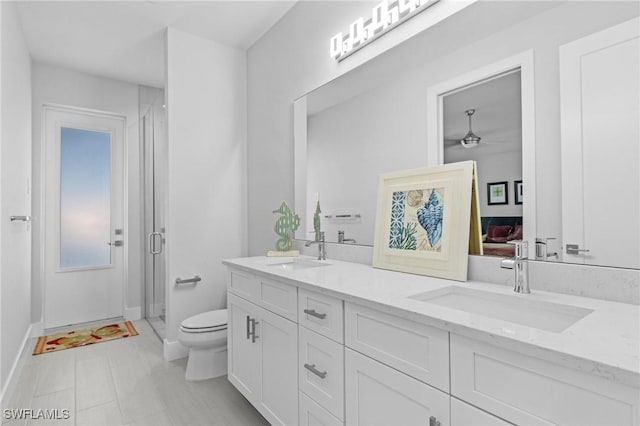 bathroom with vanity, toilet, and an enclosed shower