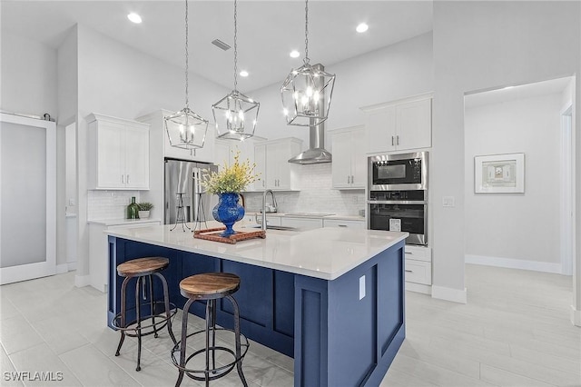 kitchen featuring white cabinets, a large island, and appliances with stainless steel finishes