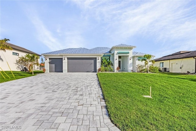 view of front of home with a garage and a front lawn