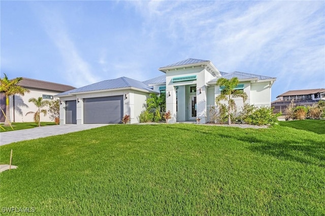 view of front of home featuring a garage and a front yard