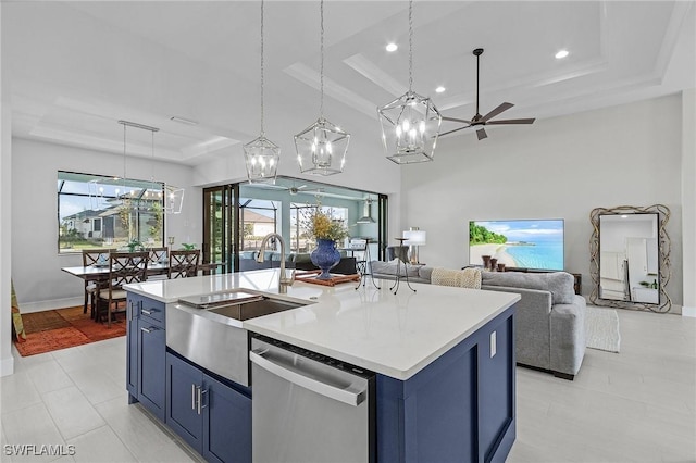 kitchen featuring a wealth of natural light, hanging light fixtures, an island with sink, and stainless steel dishwasher