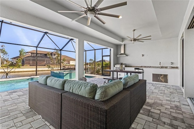 view of patio / terrace featuring an outdoor kitchen, a lanai, and sink