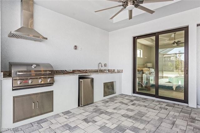 view of patio with an outdoor kitchen, ceiling fan, and a grill