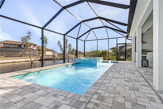 view of swimming pool with an in ground hot tub, a water view, glass enclosure, and a patio area