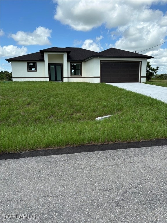 view of front facade featuring a front lawn and a garage