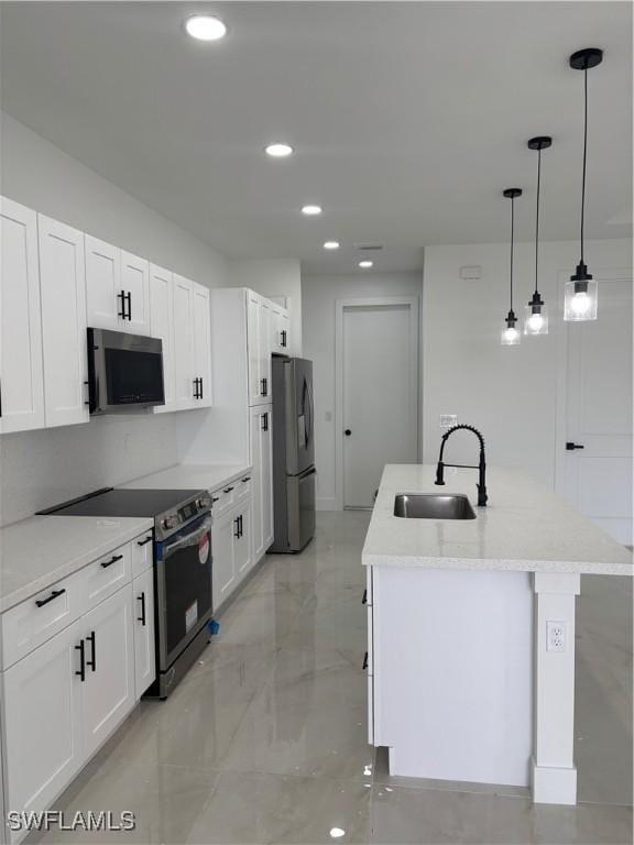 kitchen with stainless steel appliances, white cabinetry, hanging light fixtures, and sink