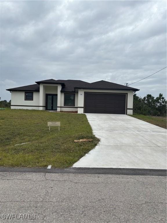 view of front of home with a garage and a front yard