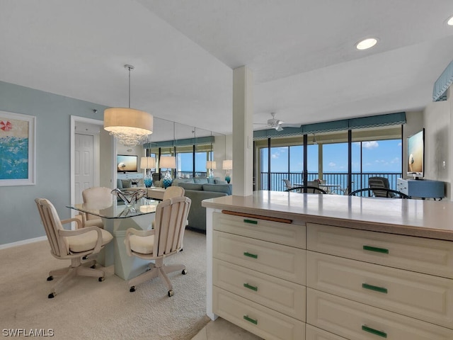 interior space with plenty of natural light, ceiling fan, and light colored carpet