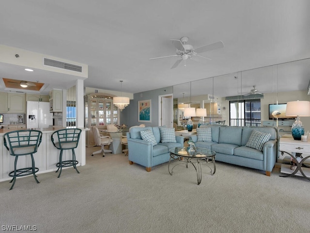 carpeted living room featuring ceiling fan