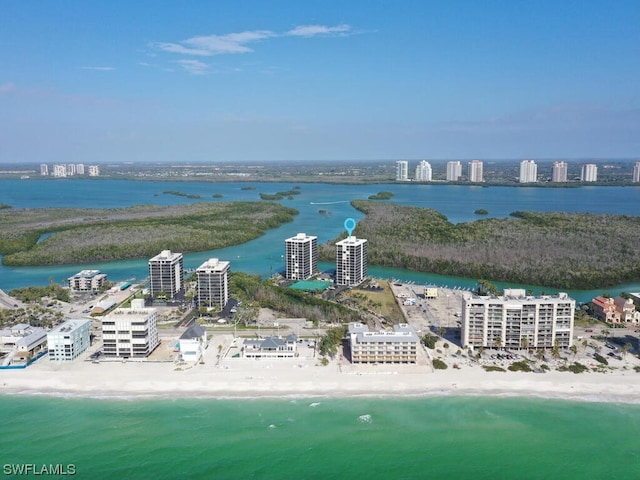 bird's eye view with a water view and a beach view