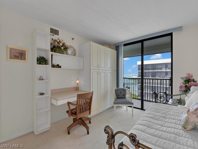 carpeted living room with a wall of windows