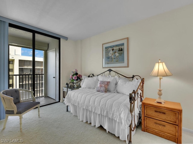 carpeted bedroom featuring a wall of windows and access to outside