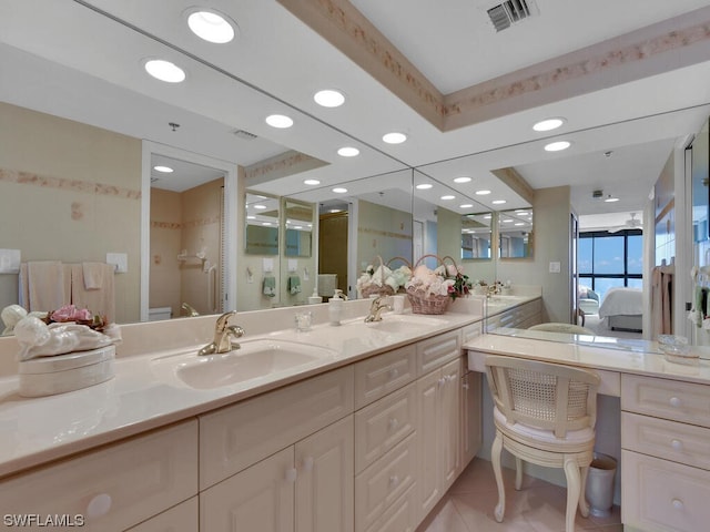 bathroom featuring dual sinks, large vanity, and tile flooring