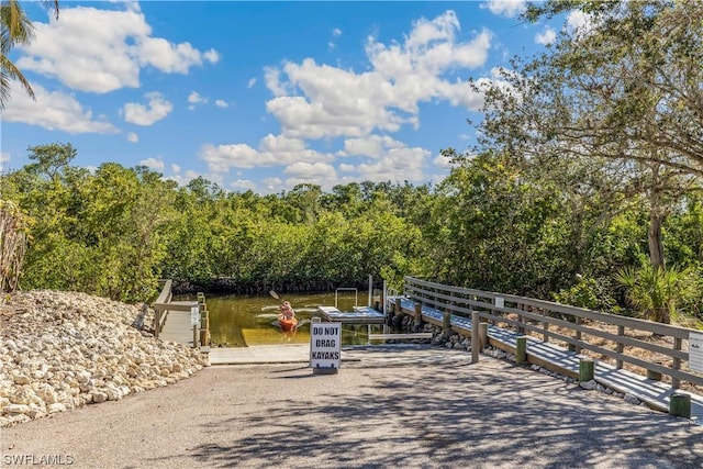 view of home's community featuring a water view and a boat dock