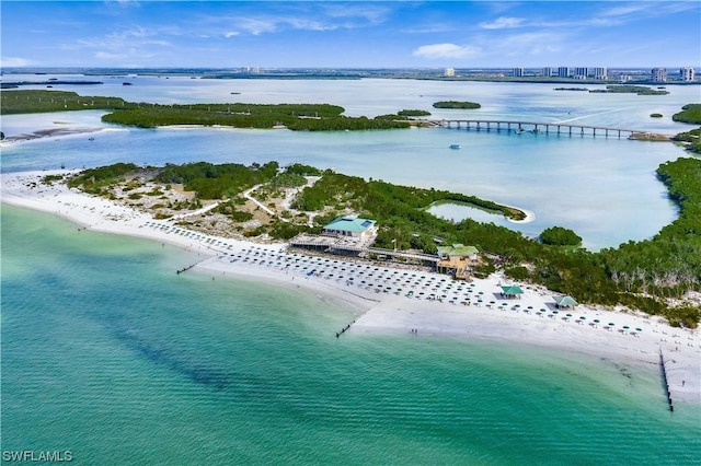 birds eye view of property with a water view and a view of the beach