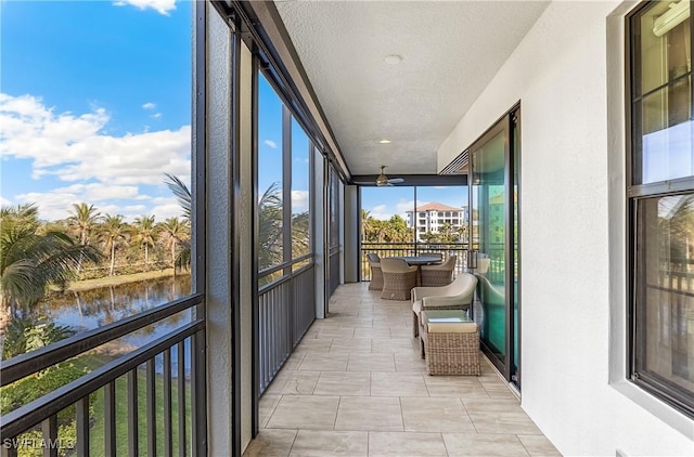 sunroom / solarium featuring a water view