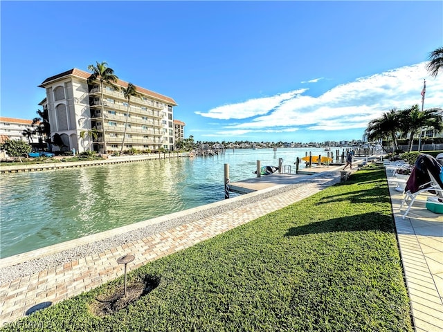 view of dock featuring a yard and a water view