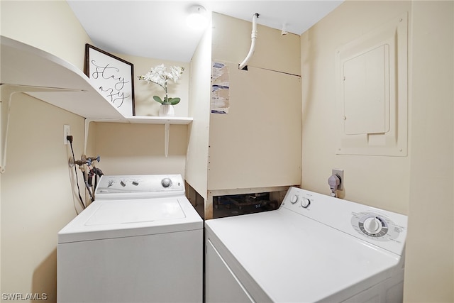 clothes washing area with electric panel and washer and clothes dryer