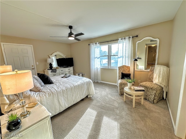 bedroom with ceiling fan and light carpet