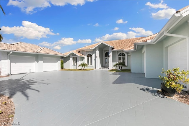 mediterranean / spanish home featuring a garage