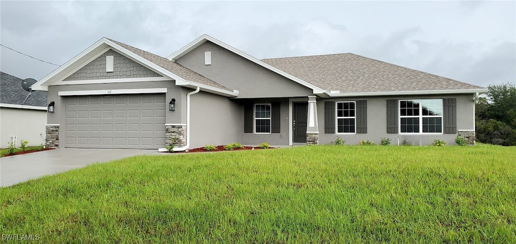 view of front of property with a garage and a front yard