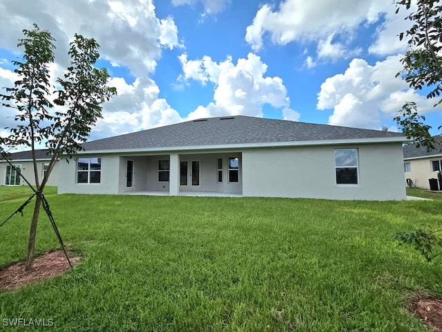 rear view of property with a lawn