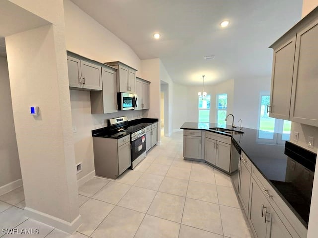 kitchen featuring appliances with stainless steel finishes, sink, and gray cabinetry