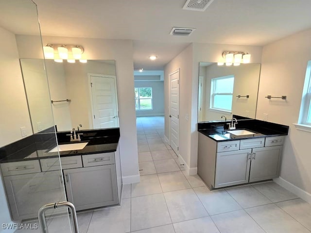 bathroom featuring tile patterned flooring, plenty of natural light, and vanity