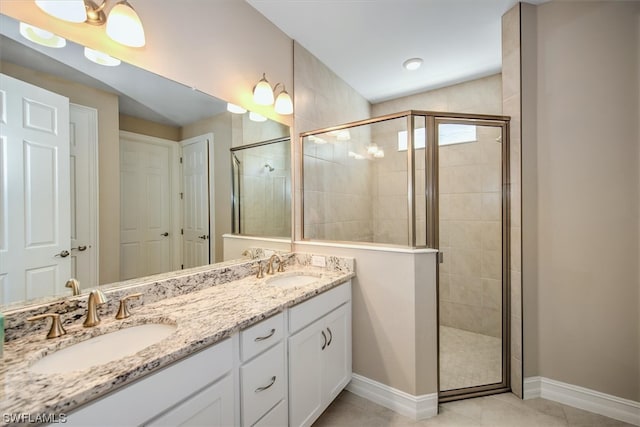 bathroom featuring tile floors, large vanity, double sink, and walk in shower