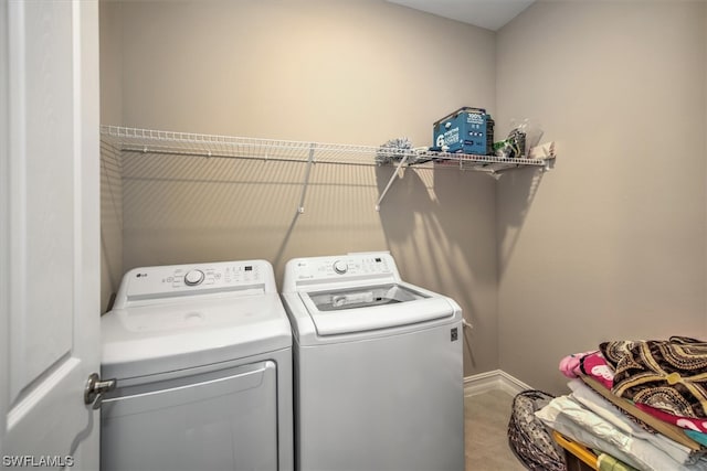 laundry area featuring independent washer and dryer and light tile floors