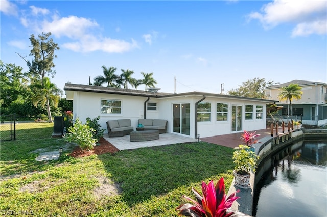 rear view of property with a yard, a patio, and an outdoor hangout area