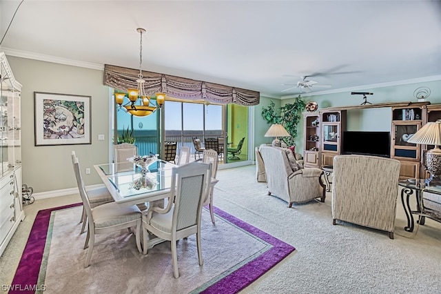 carpeted dining room with crown molding and ceiling fan with notable chandelier