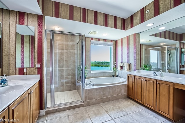 bathroom with tile flooring, separate shower and tub, and vanity