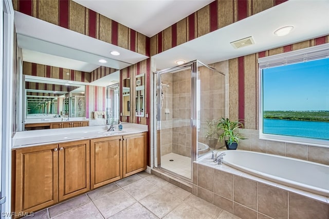 bathroom with vanity, tile floors, a wealth of natural light, and separate shower and tub