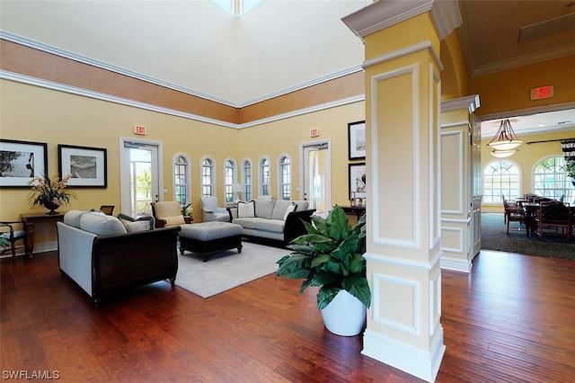 living room featuring plenty of natural light, crown molding, dark hardwood / wood-style flooring, and a high ceiling