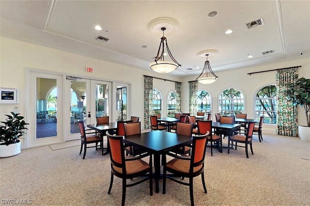 dining room with light colored carpet and french doors