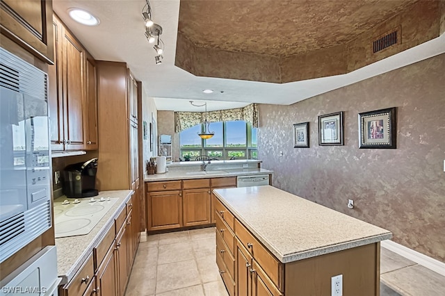 kitchen with decorative light fixtures, a kitchen island, light tile flooring, white electric stovetop, and sink