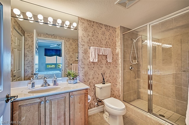 bathroom featuring walk in shower, toilet, tile floors, oversized vanity, and a textured ceiling