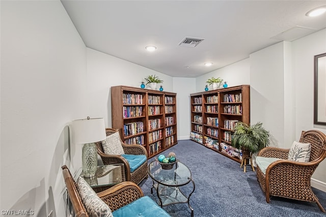 sitting room featuring dark carpet