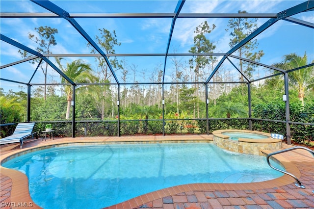 view of pool with a lanai and an in ground hot tub