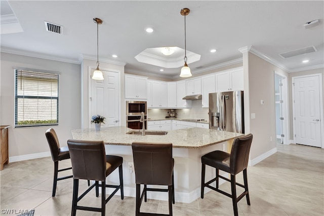 kitchen featuring a large island, hanging light fixtures, white cabinets, and stainless steel appliances