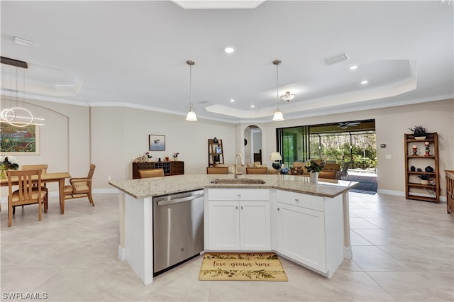 kitchen featuring stainless steel dishwasher, a tray ceiling, sink, pendant lighting, and white cabinets