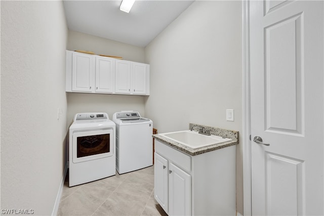 laundry room featuring cabinets, separate washer and dryer, light tile patterned flooring, and sink