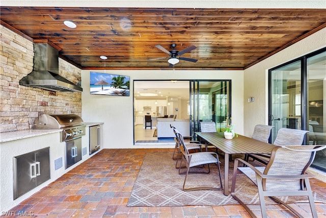 view of patio with ceiling fan, exterior kitchen, and grilling area