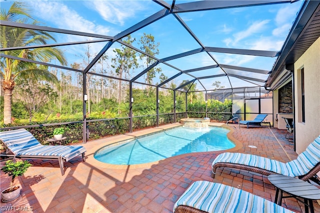 view of pool featuring a lanai, an in ground hot tub, and a patio